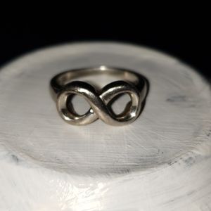 A silver Infinity ring.